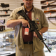 Shop owner Jeff Binkley displays an AR-15 “Sport” rifle at Sarge’s Sidearms on Sept. 29, 2016, near Benson, Ariz.